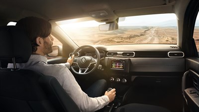 A picture from the back seat of a man driving All-New Renault Duster